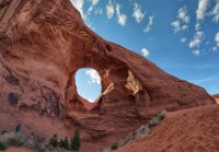 IMG 7890-7935-HDR(3) stitch  Ear-of-the-Wind Arch. See Anni in the lower left of this composite picture of this formation?  She gives some idea of the size.