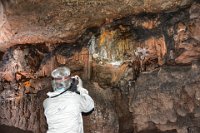 BobsPics-DSC 5682-HDR  Suzanne finds some stalactites and columns (where stalactites and stalagmites have merged together).  Unfortunately this area seemed to be dry which means that are not growing.