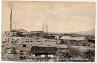 Sasco1907  The Southern Arizona Smelting Company or SASCO smelter as it appeared some time in the period of 1907 to 1912, the short time when it operated.  It smelted ore from the old Siverbell Mine which is about 12 miles away.  Accommpaning the smelter was a town of about 600 people which had a post office, hotel (or boarding house) and a jail, the latter two features were in previous photographs in this photo album.  We didn't see any signs of houses, but didn't look that closely.  The post office closed in 1919.  A railroad between the smelter and the mine brought the ore here for smelting.  The large stack in the picture was 175 ft. tall - only the base, or foundation, exists today.